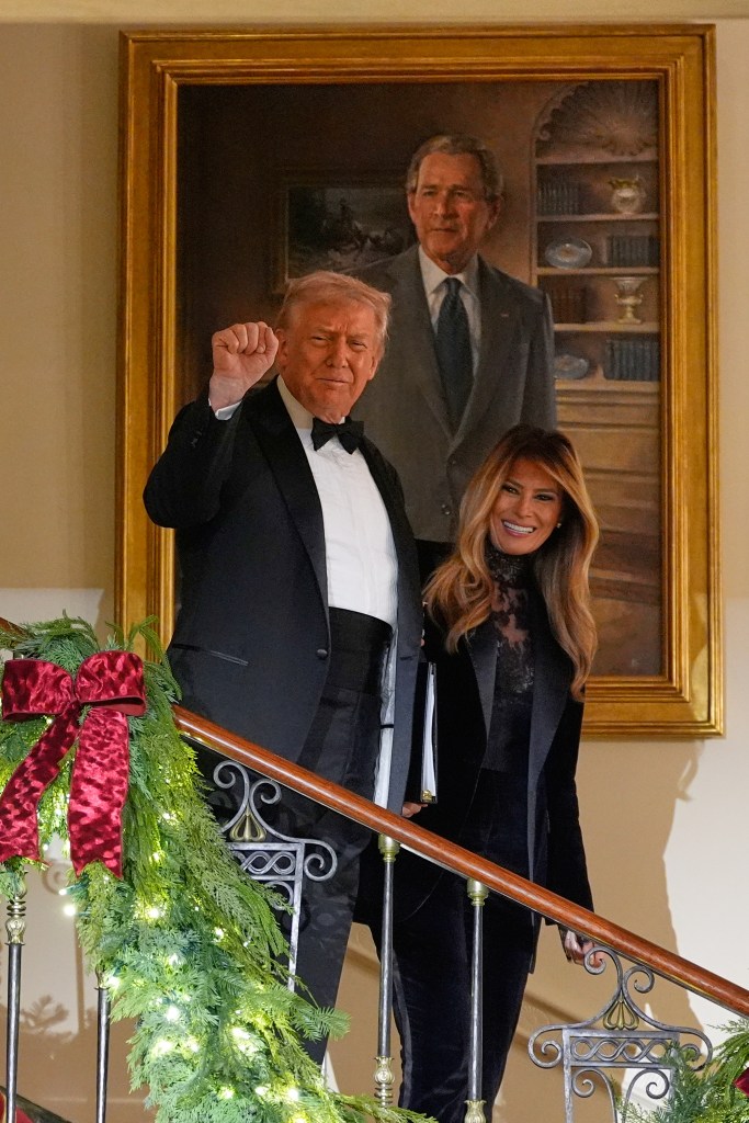 President Donald Trump and first lady Melania Trump descend the stairs to the Grand Foyer at the White House for the Congressional Ball.