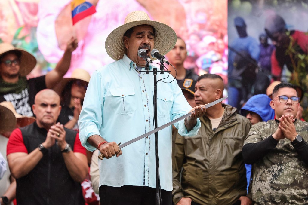 Maduro gives a speech holding the sword of independence hero Ezequiel Zamora during a commemoration march for the 166th Anniversary of the Battle of Santa Inés on December 10, 2025 in Caracas, Venezuela.