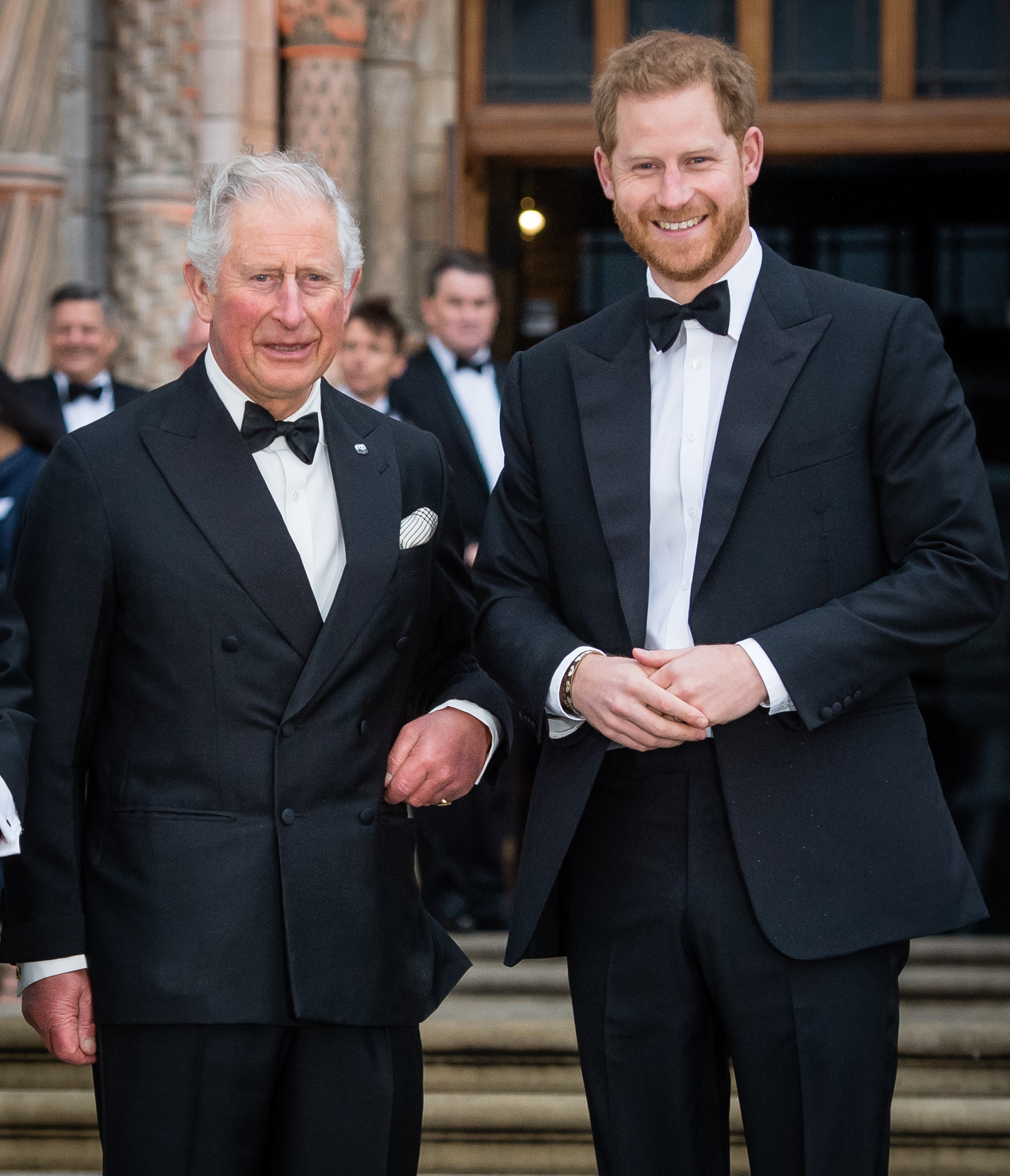 Prince Charles and Prince Harry in black tuxedos.