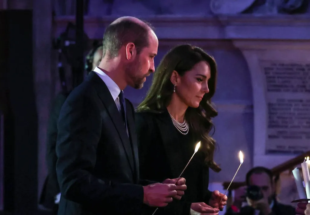 Prince William and Kate Middleton holding lit candles.