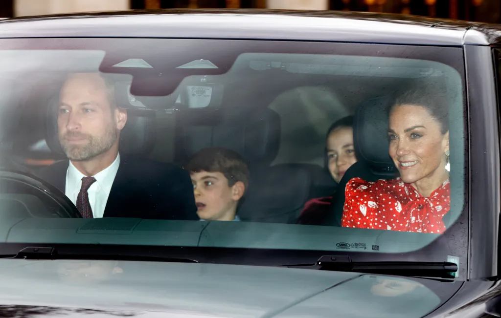 Prince William, Prince Louis, Princess Charlotte, and Catherine, Princess of Wales, in a car arriving at Buckingham Palace.