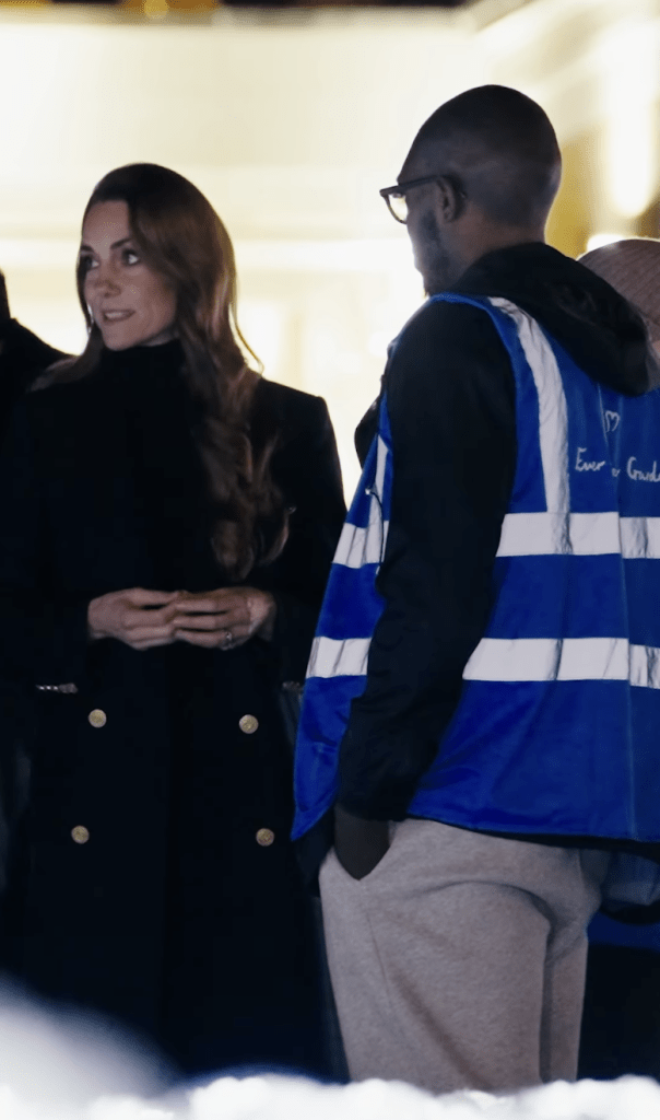 Princess Kate speaking with a man wearing a blue reflective vest at the Ever After Garden.