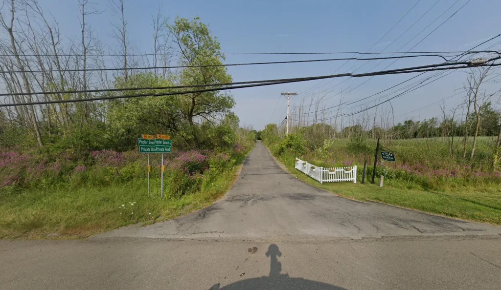A private road in New York leading to Poplar Beach, owned by John Jay Hoff and Kathleen Ocorr Hoff.