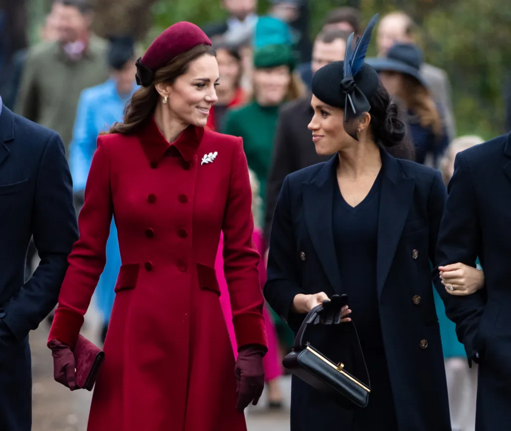 Catherine Duchess of Cambridge and Meghan Duchess of Sussex walking together, smiling.