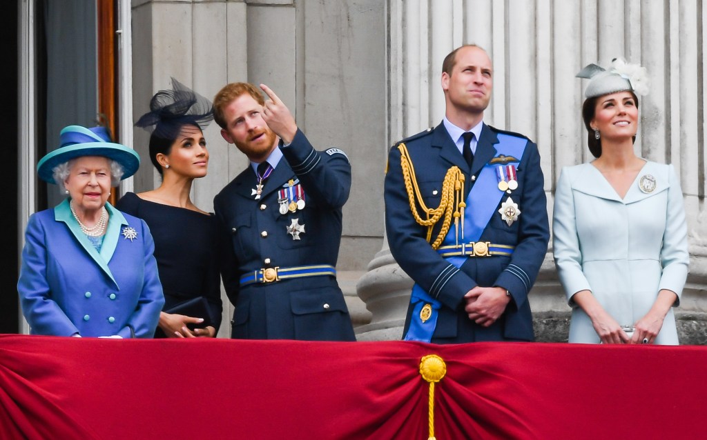 Queen Elizabeth II, Meghan Markle, Prince Harry, Prince William, and Kate Middleton standing on the balcony of Buckingham Palace.