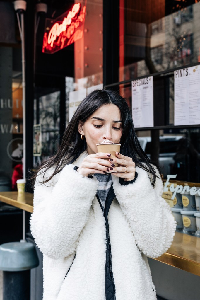Rachel Brotman of The Carboholic drinking Caffe Panna’s hot chocolate.
