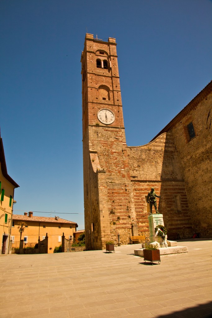 A brick clock tower and building in Radicondoli, Siena, Italy.