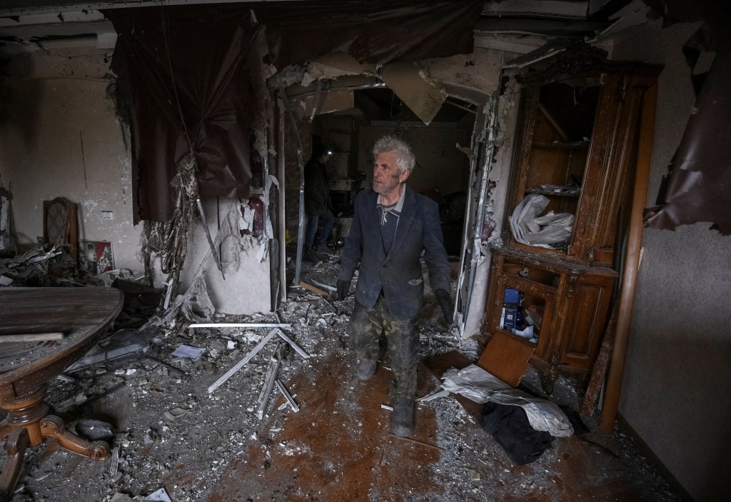 A resident walks through a building damaged in the attack on Dec. 6, 2025.