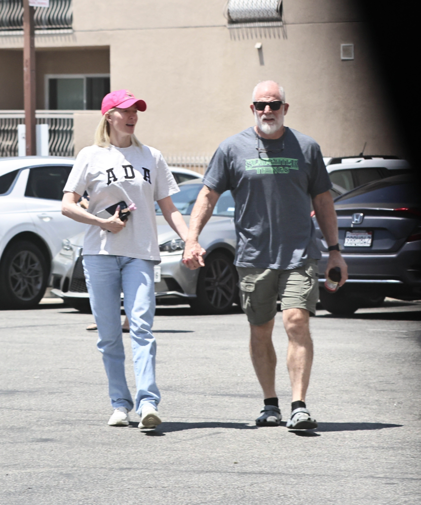Erika Jayne holding hands with John McPhee.