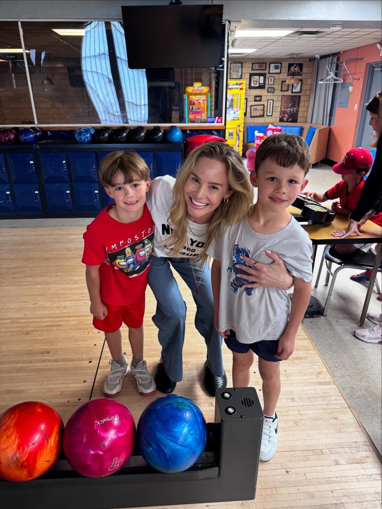 Meghan King poses with her two sons at a bowling alley.