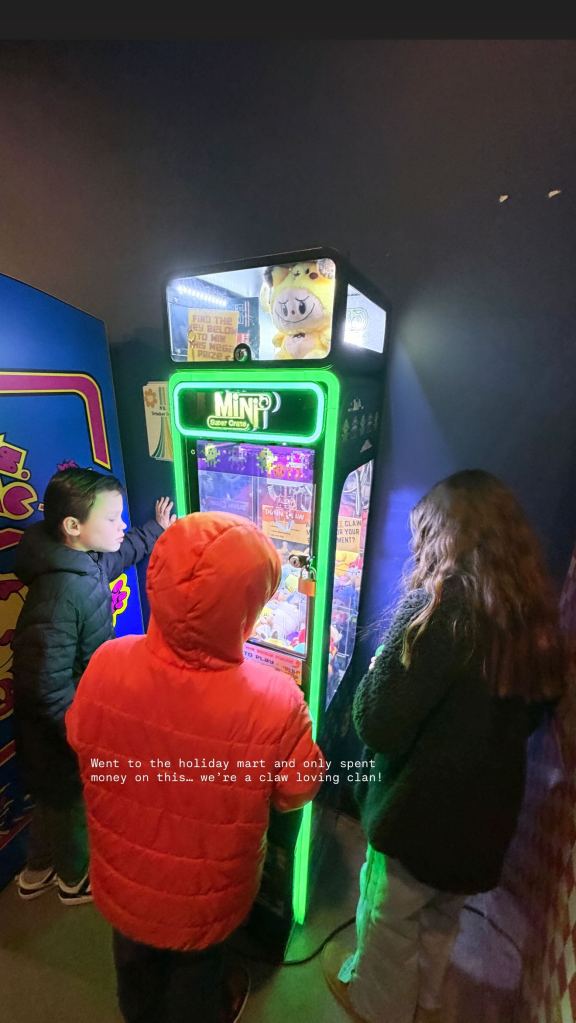 Meghan King's children playing a claw machine.