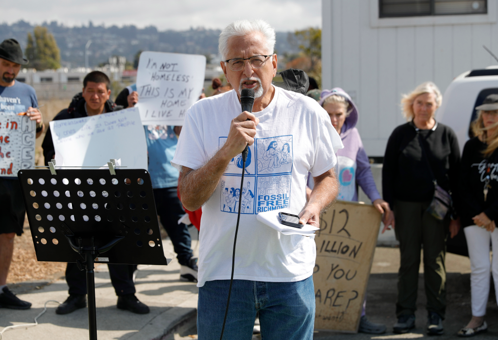 Richmond Vice Mayor Eduardo Martinez speaking into a microphone at a homeless encampment press conference.