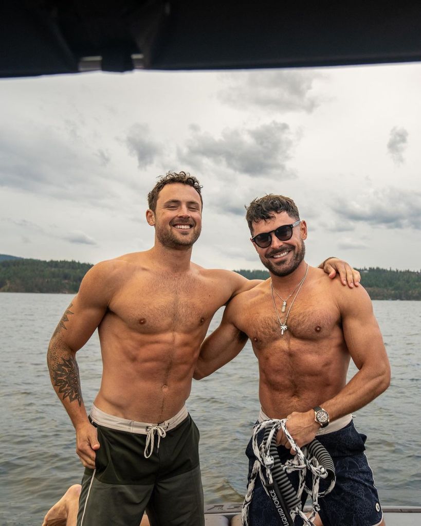 Zac Efron and his brother Dylan, shirtless on a boat.