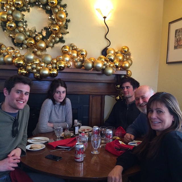 Rob Reiner with Michele, Romy, Nick and Jake at a table with holiday decorations.