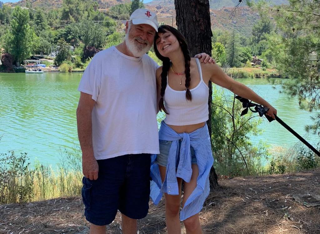 Rob and Romy Reiner smiling by a lake.