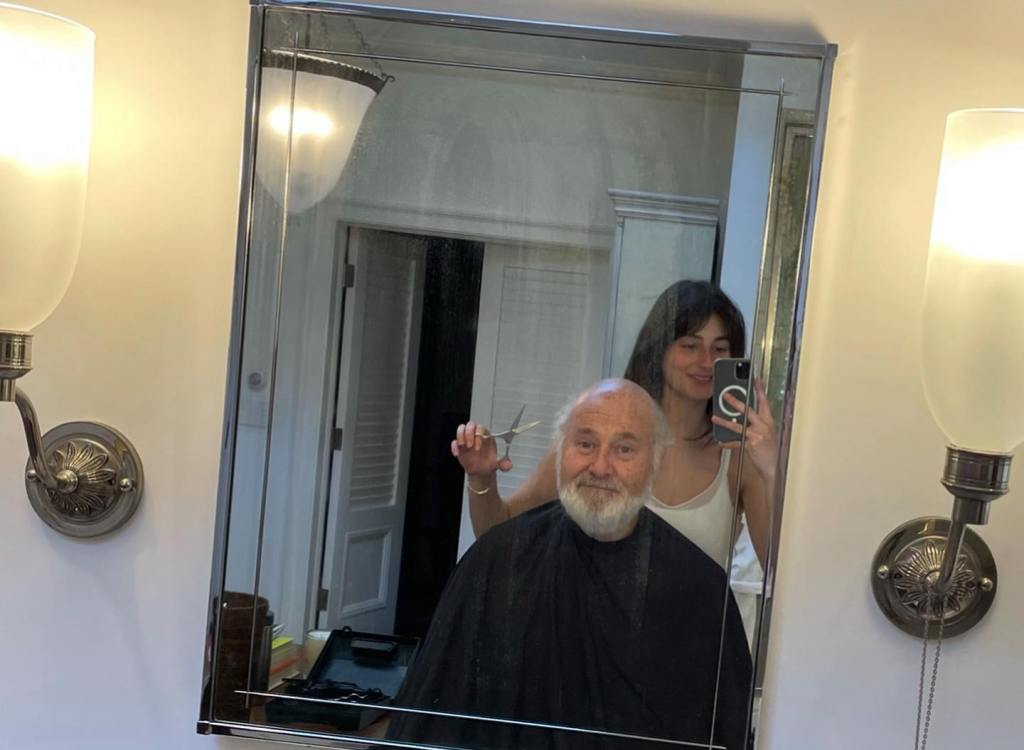 Romy Reiner cutting Rob Reiner's hair.