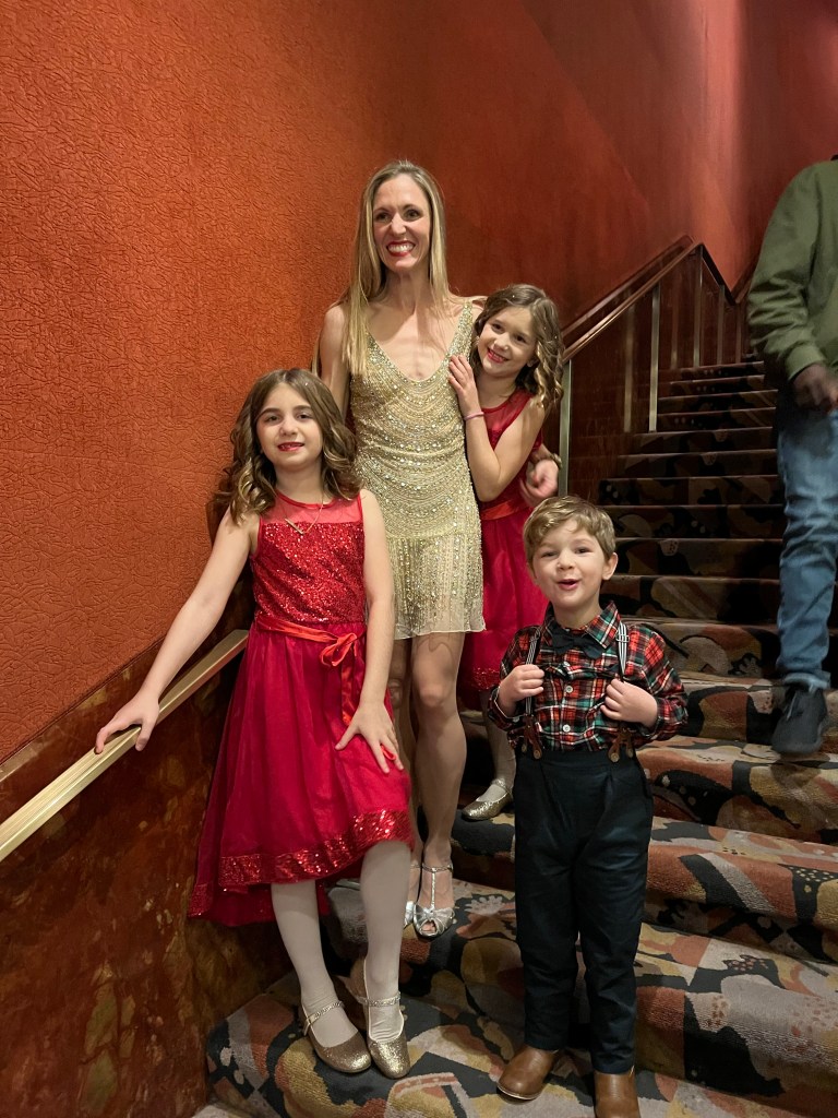 Alina Silver with her two daughters and son on a staircase at Radio City Music Hall