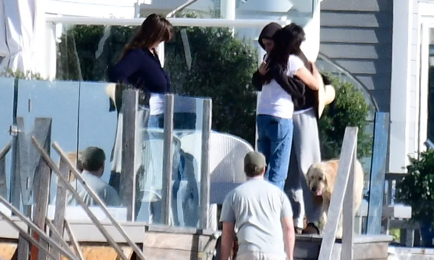 Romy Reiner and Adam Silberberg being comforted by a family friend at the Reiner family beach house in Malibu.