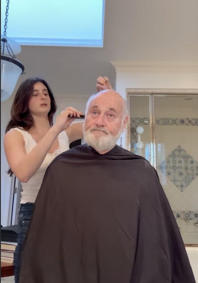 Romy Reiner giving her dad Rob a haircut.