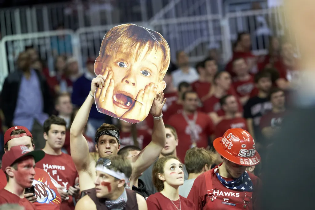 Saint Joseph's fan in stands holding up cardboard cutout of Macauly Culkin screaming during game vs Notre Dame at Barclays Center on Nov. 16, 2012.