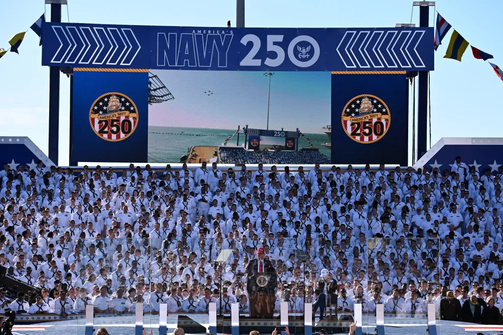 US President Donald Trump speaks to a crowd of US Navy personnel.