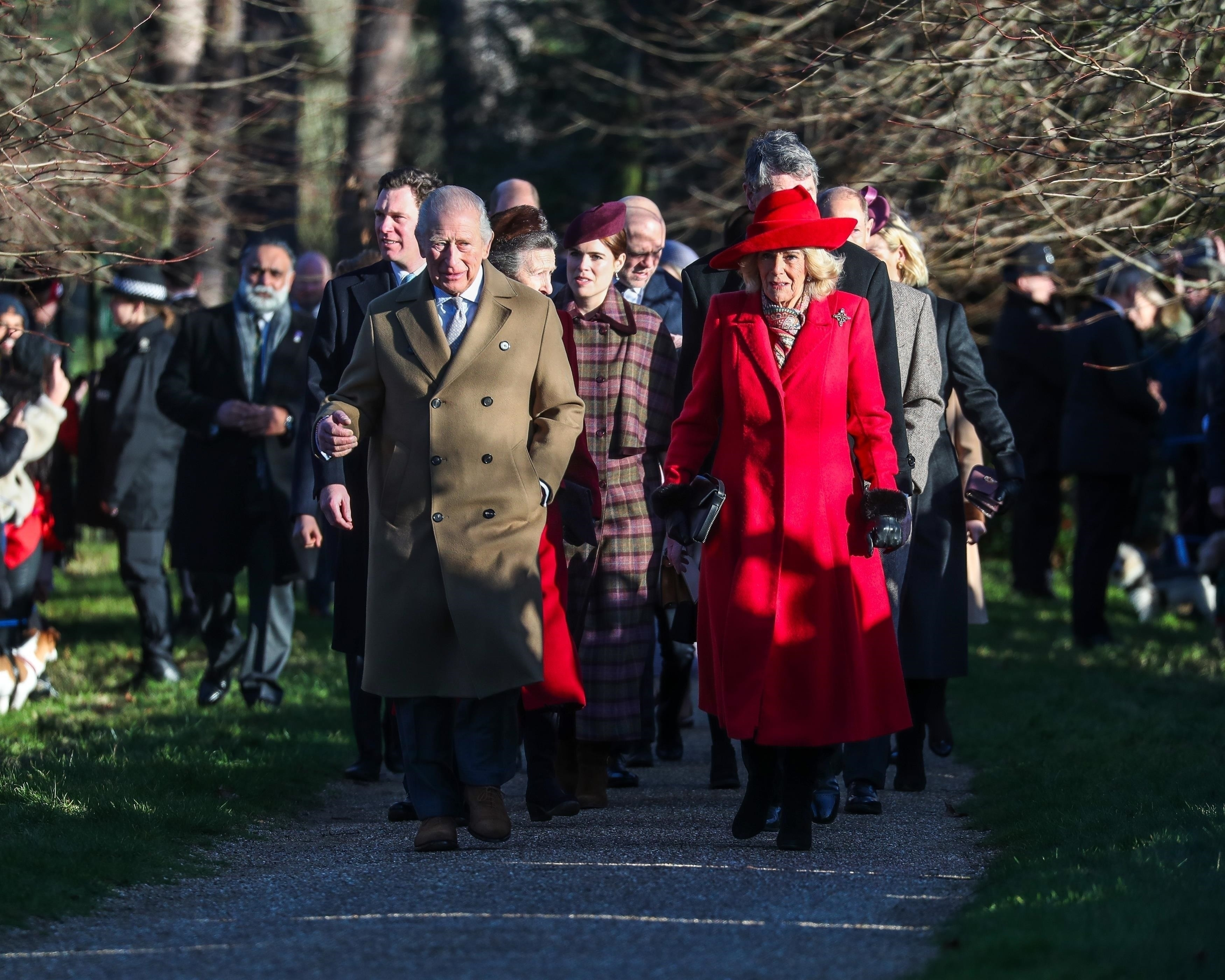 King Charles III and Queen Camilla walking with members of the Royal Family at Sandringham.