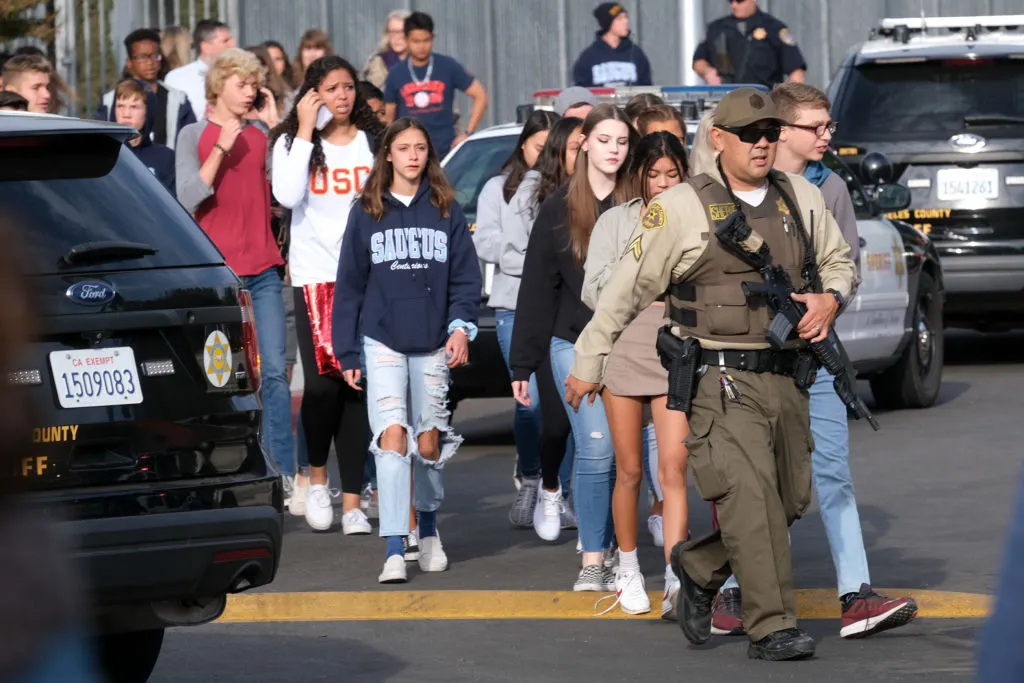 Students are escorted off campus after a shooting occurred at Saugus High School on Nov. 14, 2019. 