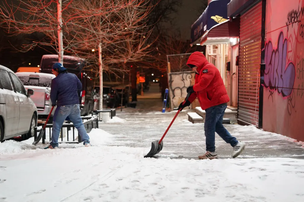 New Yorkers shovel snow from the storm that was due to drop anywhere between 6 to 10 inches of snow in the New York City Metro area on December 26, 2025.