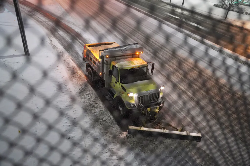 A snowplow clears a roadway in Paramus, NJ, after the New York Metro area got between 6 to 10 inches of snow during an overnight storm.