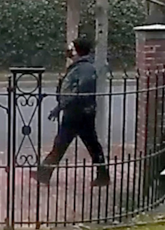 Security camera footage of the Brown University shooting suspect walking outdoors.