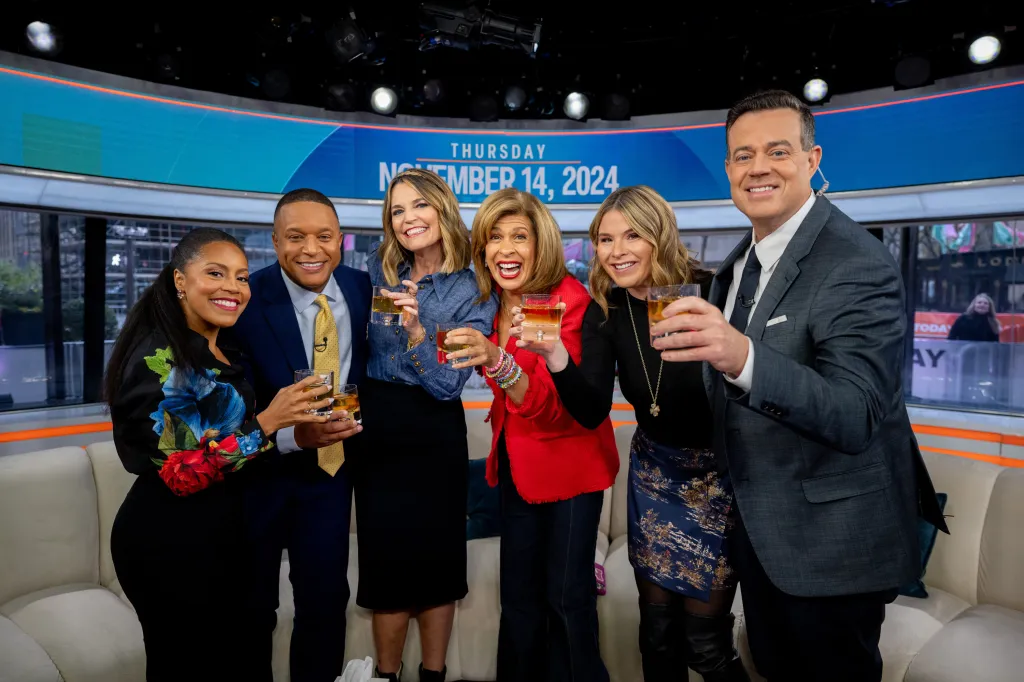 Sheinelle Jones, Craig Melvin, Savannah Guthrie, Hoda Kotb, Jenna Bush Hager and Carson Daly raise drinks on the TODAY show.