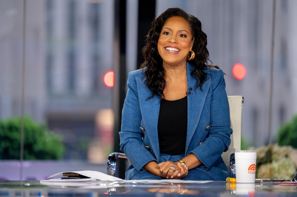 Sheinelle Jones sitting on a talk show set.