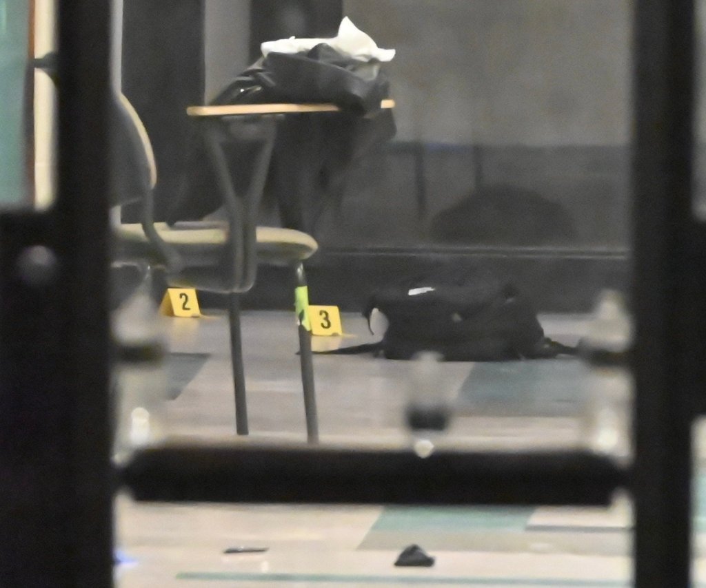 Shell casings are highlighted with evidence markers inside a building at Brown University following a mass shooting.