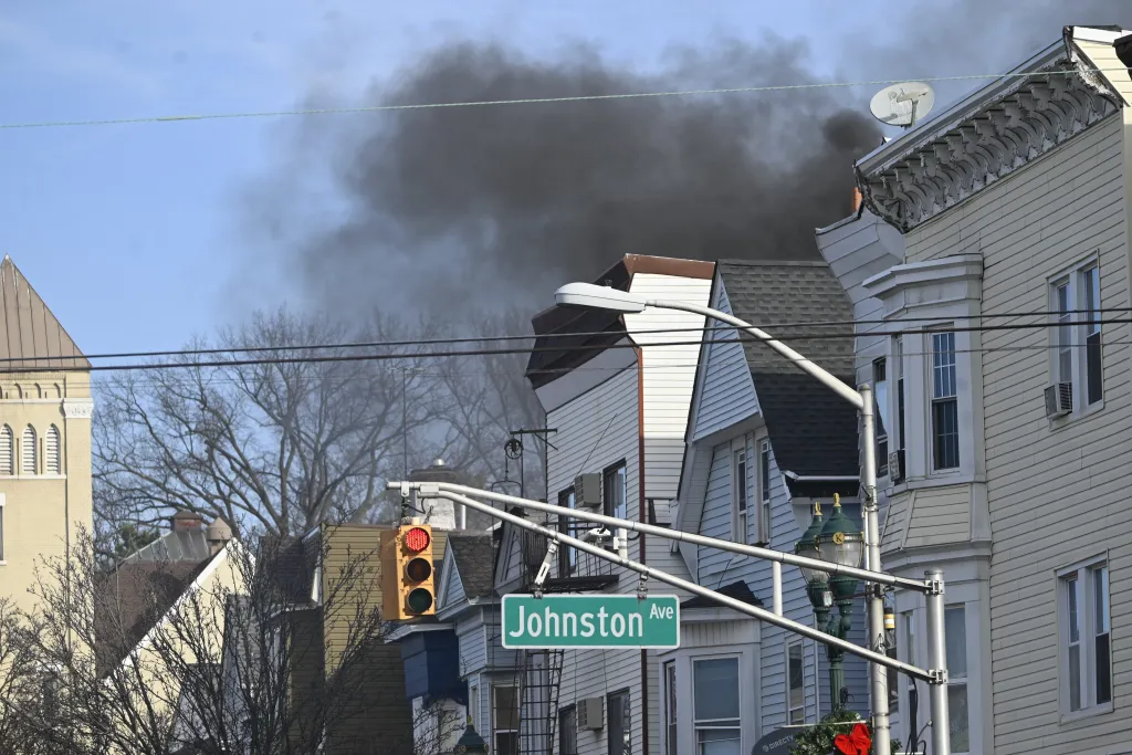Thick black smoke rising above residential buildings on Kearny Avenue and Johnston Avenue in New Jersey.