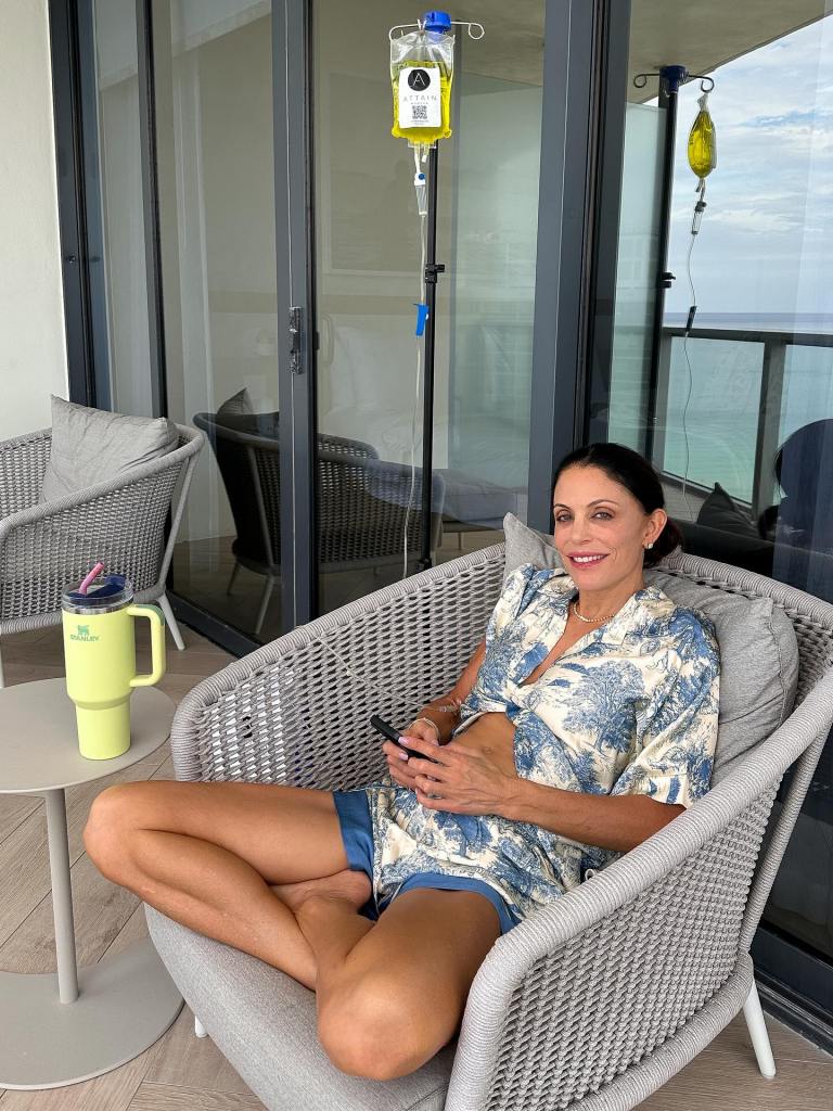 Bethenny Frankel receiving an IV infusion while relaxing on a balcony.