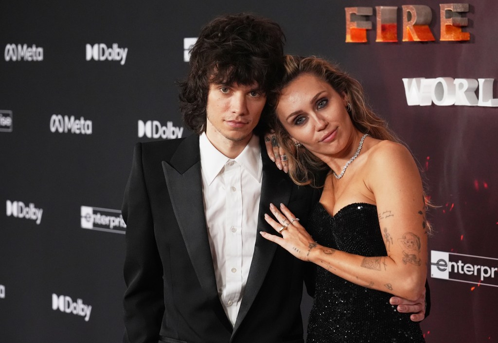 Miley Cyrus posing with Maxx Morando at the premiere of 
