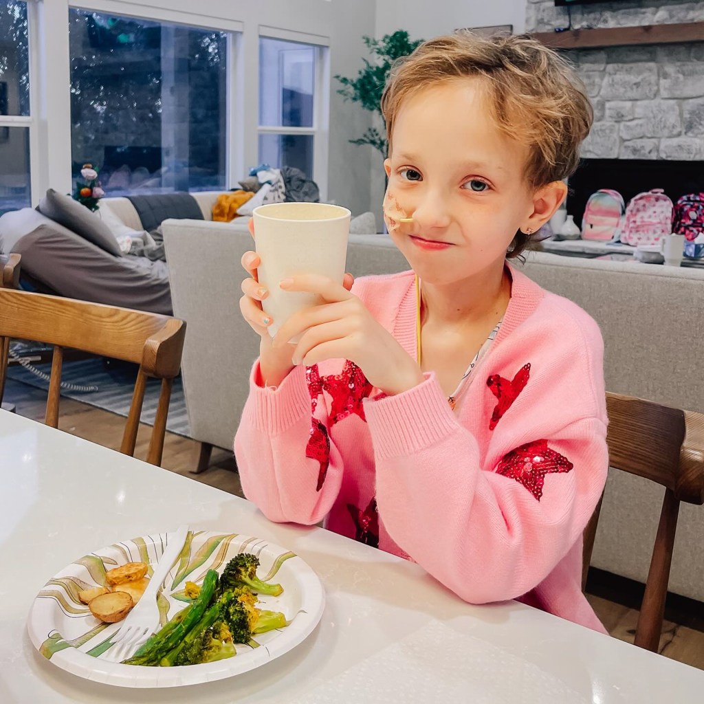 Brie Bird smiles for the camera amid a meal.