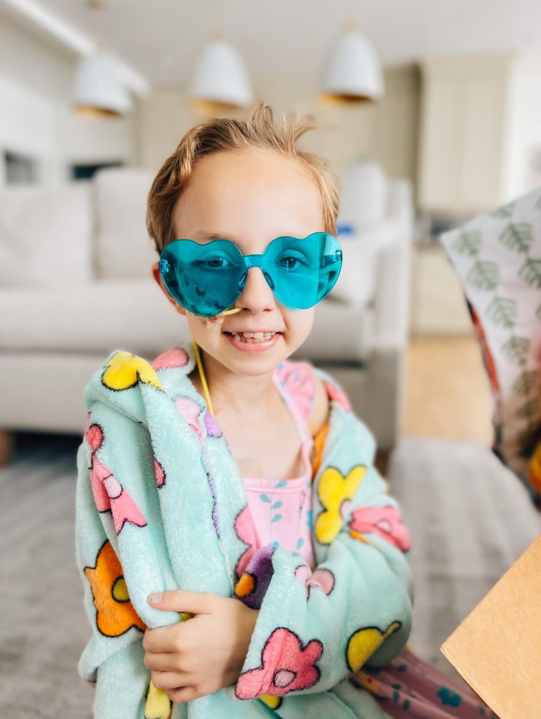 Brie Bird sports heart shaped sunglasses.