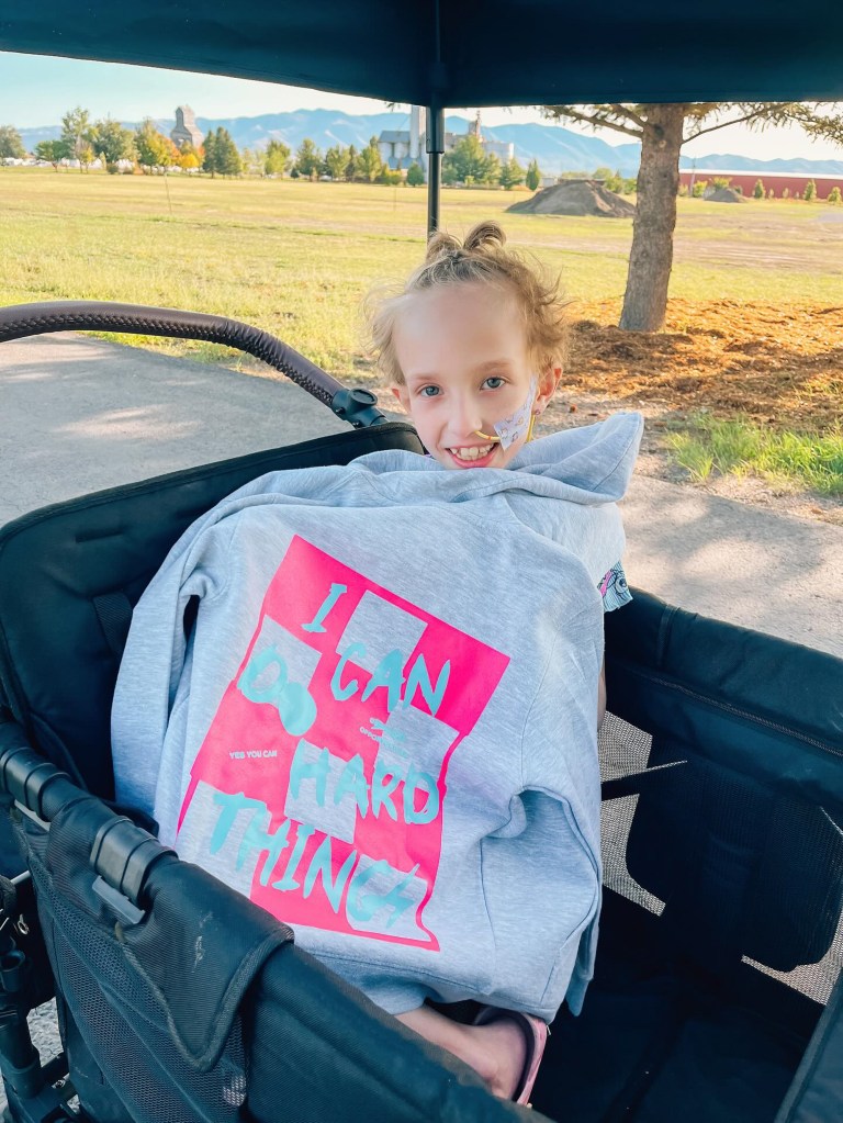 Brie Bird smiles as she's wrapped in a blanket.