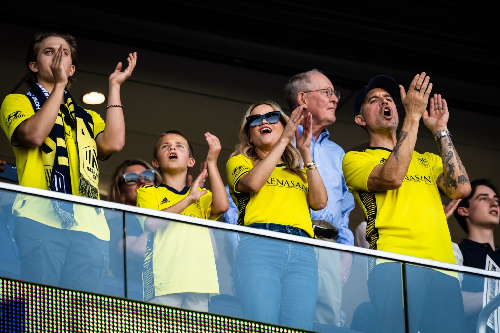 Reese Witherspoon, her two sons, and husband Jim Toth cheering on the Nashville Soccer Club.