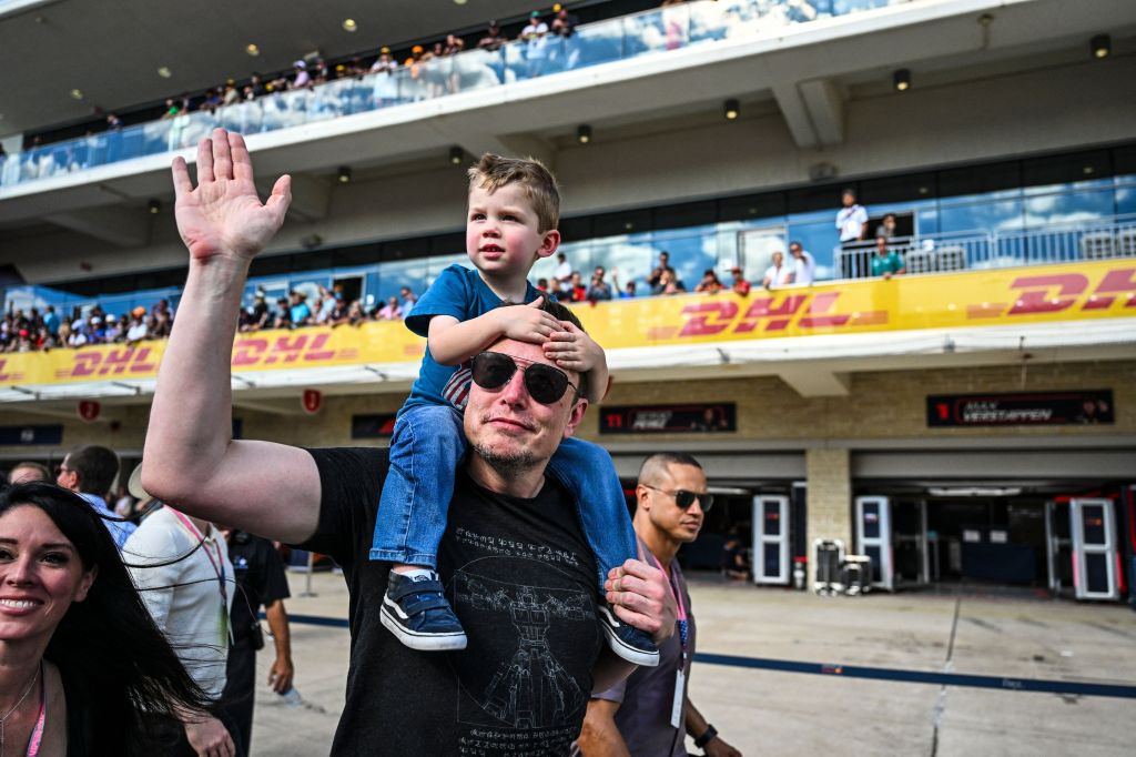 Elon Musk with his son walking on the pit lane after the 2023 United States Formula One Grand Prix.