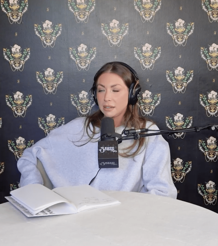 Stassi Schroeder podcasting with a microphone and headphones.