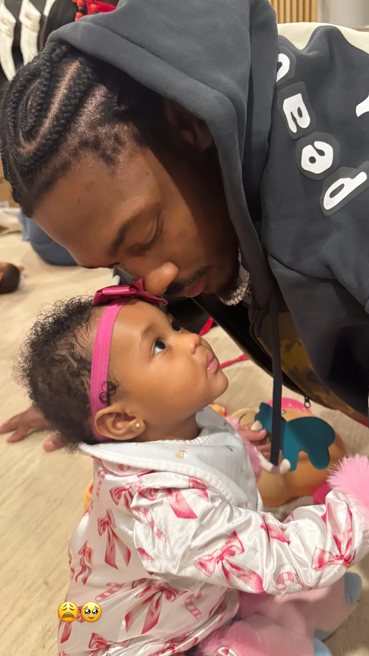 Stefon Diggs leaning in close to his daughter.