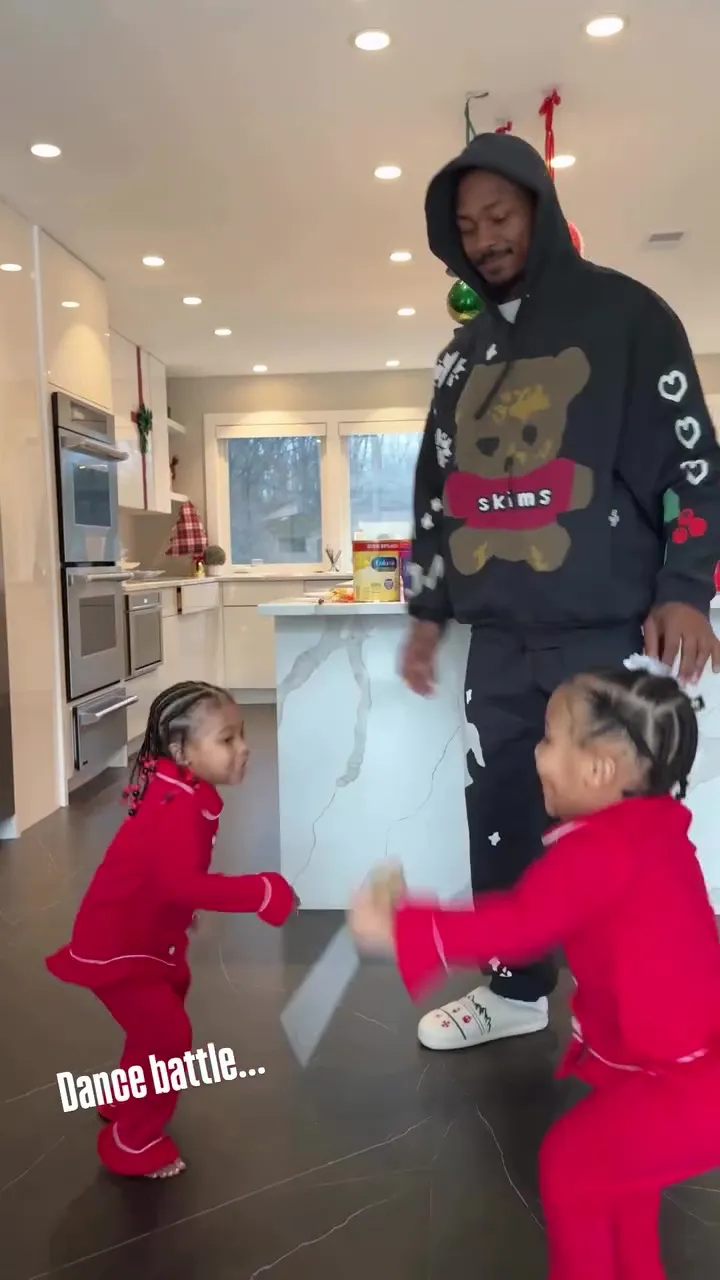 Stefon Diggs dancing with his 2-year-old daughter Shiloh and another young girl in a kitchen.