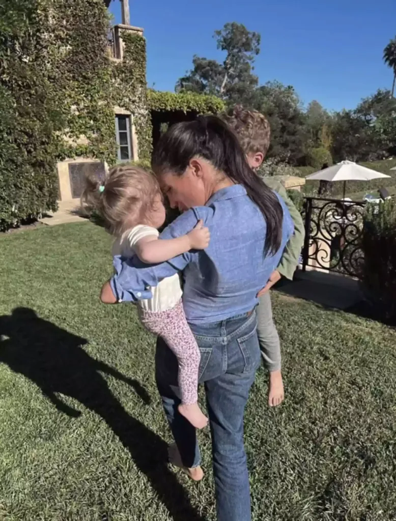 Meghan Markle holds her baby in a candid shot. 