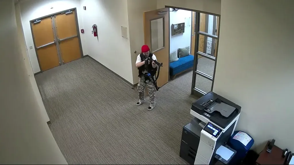 Still image from surveillance video shows Audrey Elizabeth Hale holding a rifle.