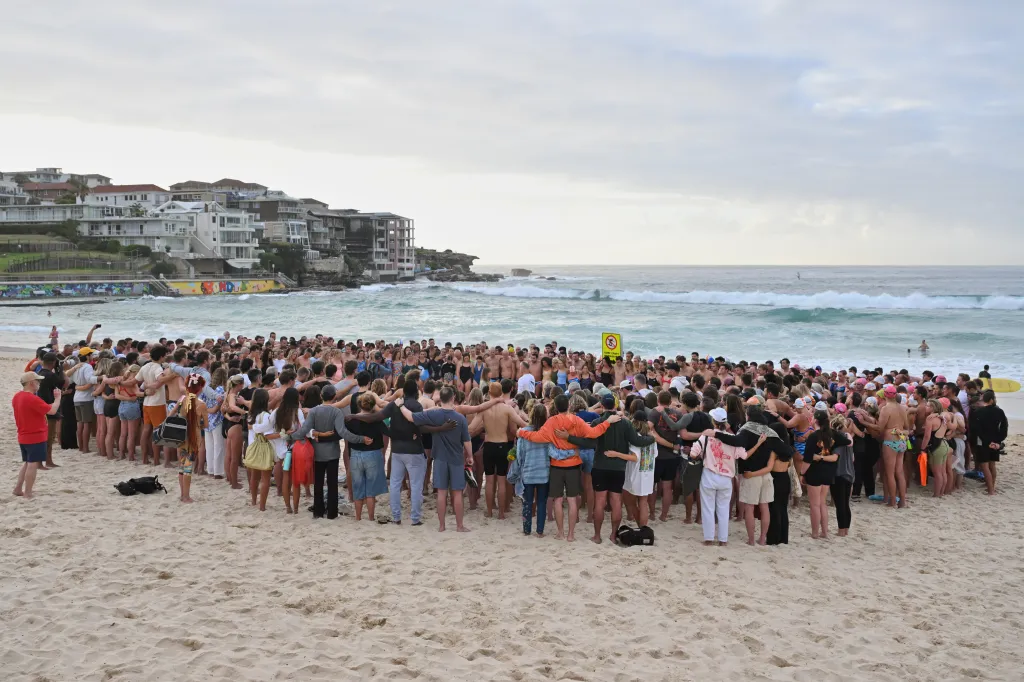 Swimmers gather for a morning vigil in Sydney, following Sunday's shooting at Bondi Beach.