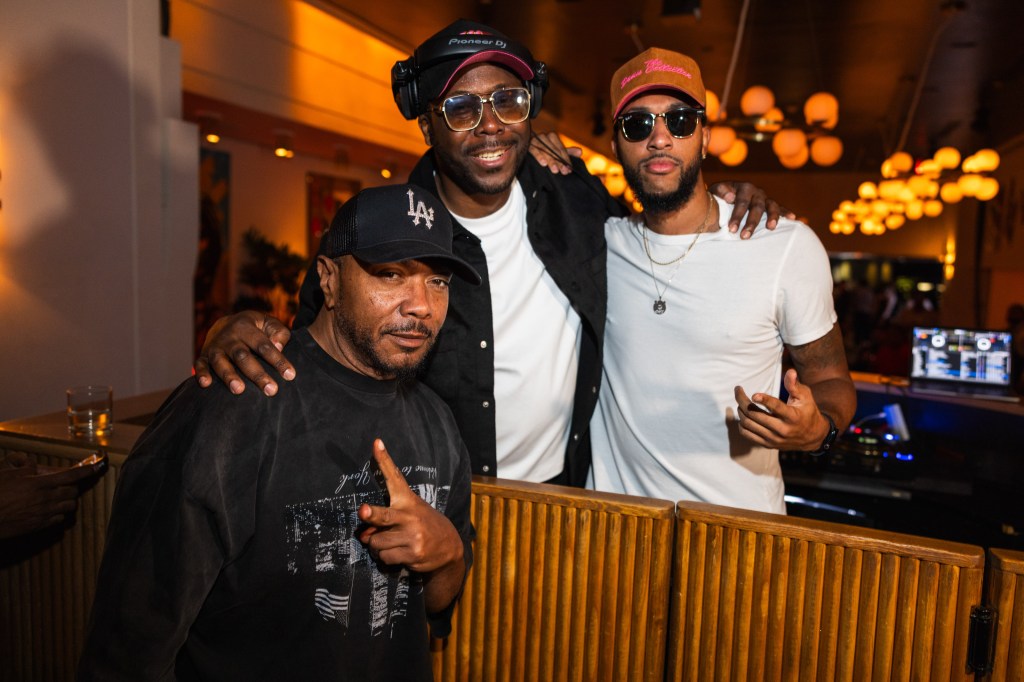 Timbaland and two men pose for a photo at a Miami Art Basel party.