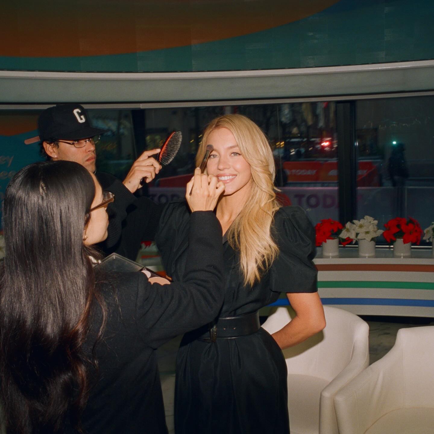 Sydney Sweeney getting glam with a makeup artist and hairstylist.