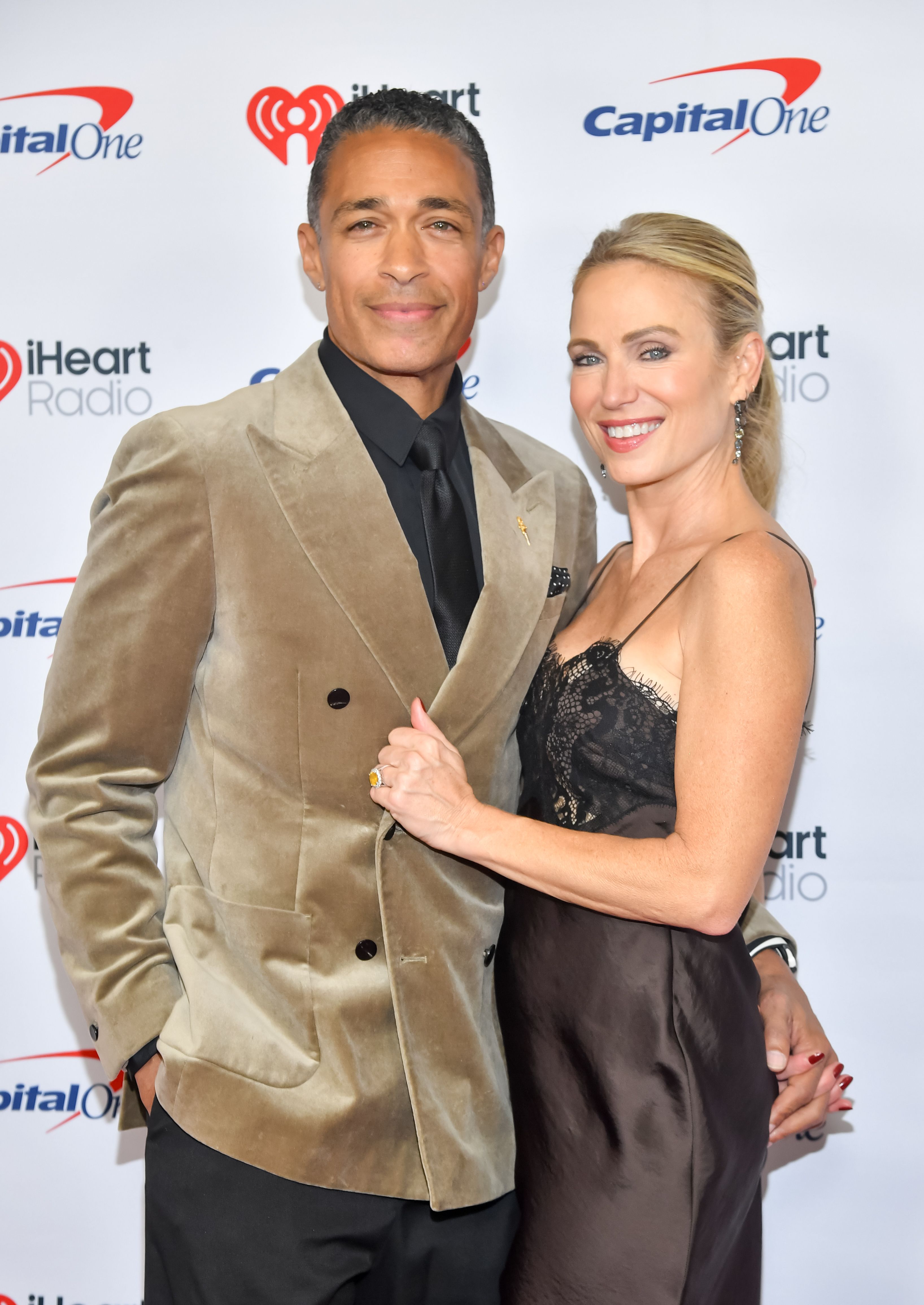 T. J. Holmes and Amy Robach in coordinated brown-toned outfits.